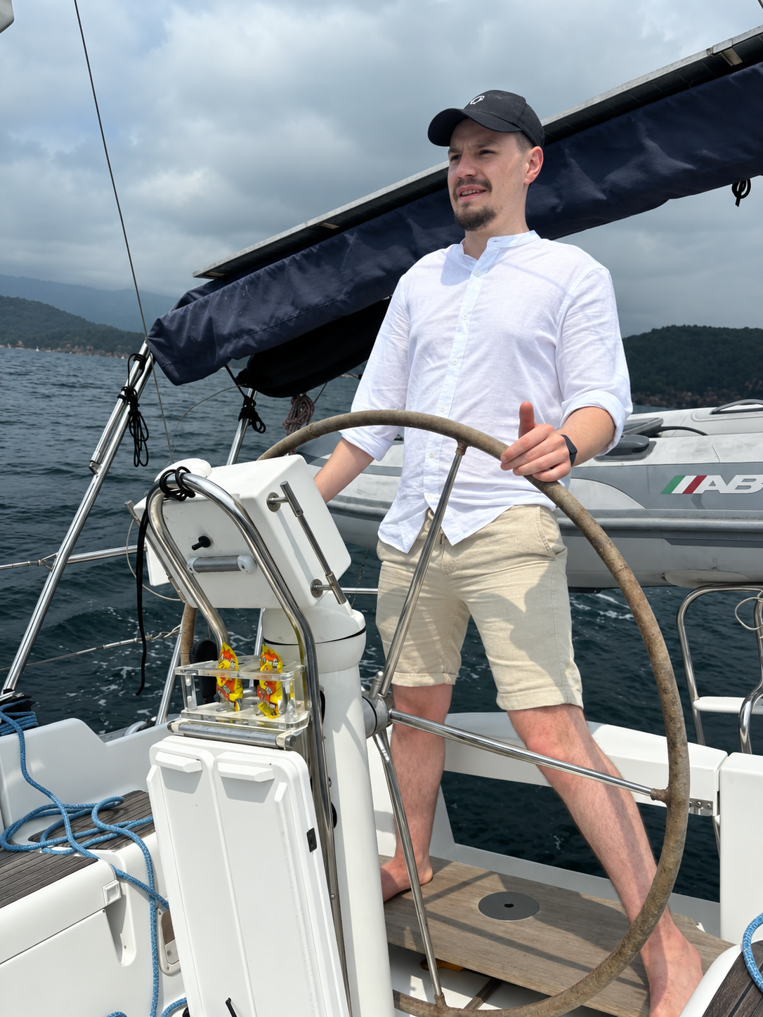Oscar Kneip at the helm of a sailboat